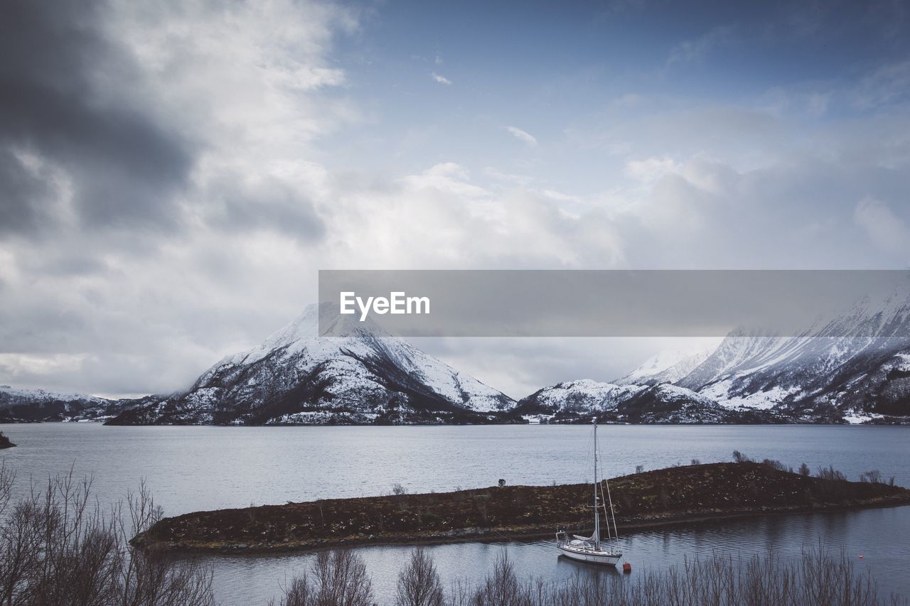 Scenic view of lake against sky during winter