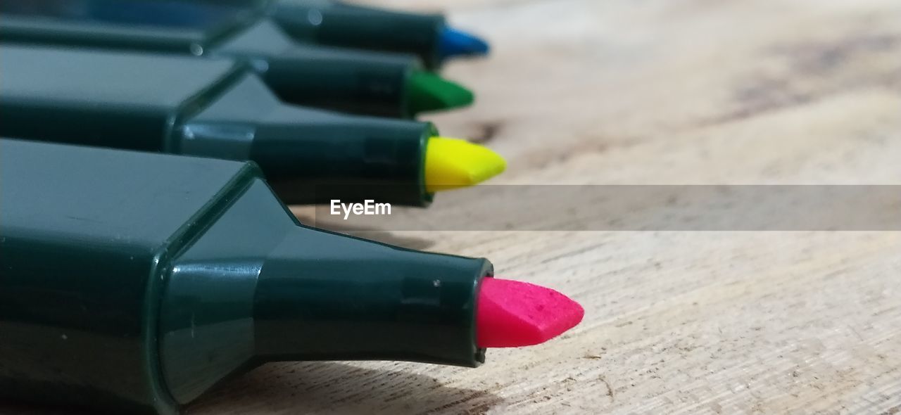 HIGH ANGLE VIEW OF COLORED PENCILS ON TABLE