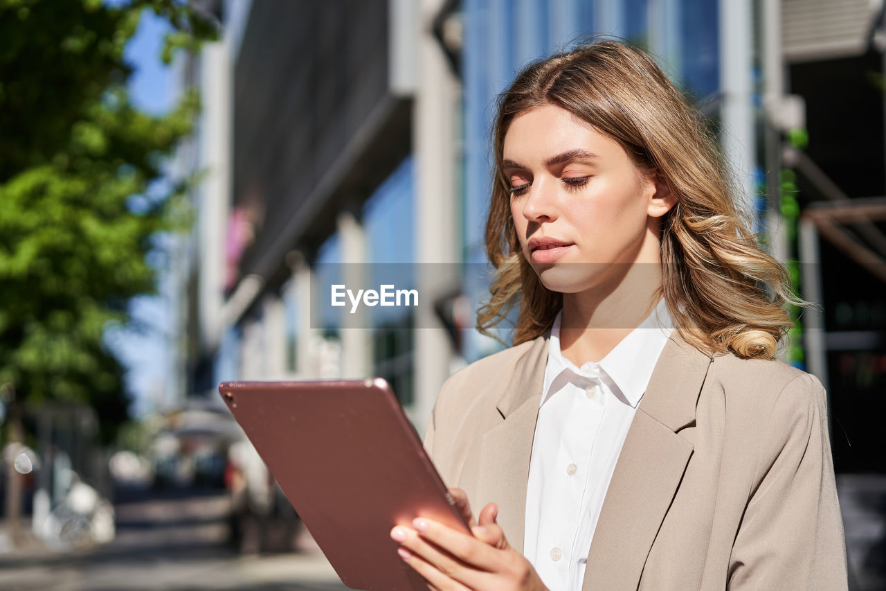 portrait of young businesswoman using mobile phone