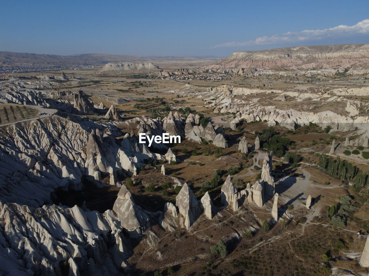 environment, landscape, scenics - nature, nature, sky, mountain, travel destinations, land, beauty in nature, geology, travel, no people, non-urban scene, rock, valley, day, mountain range, outdoors, tourism, tranquility, tranquil scene, aerial photography, clear sky, plateau, blue, high angle view, architecture, wilderness, desert, remote, rock formation