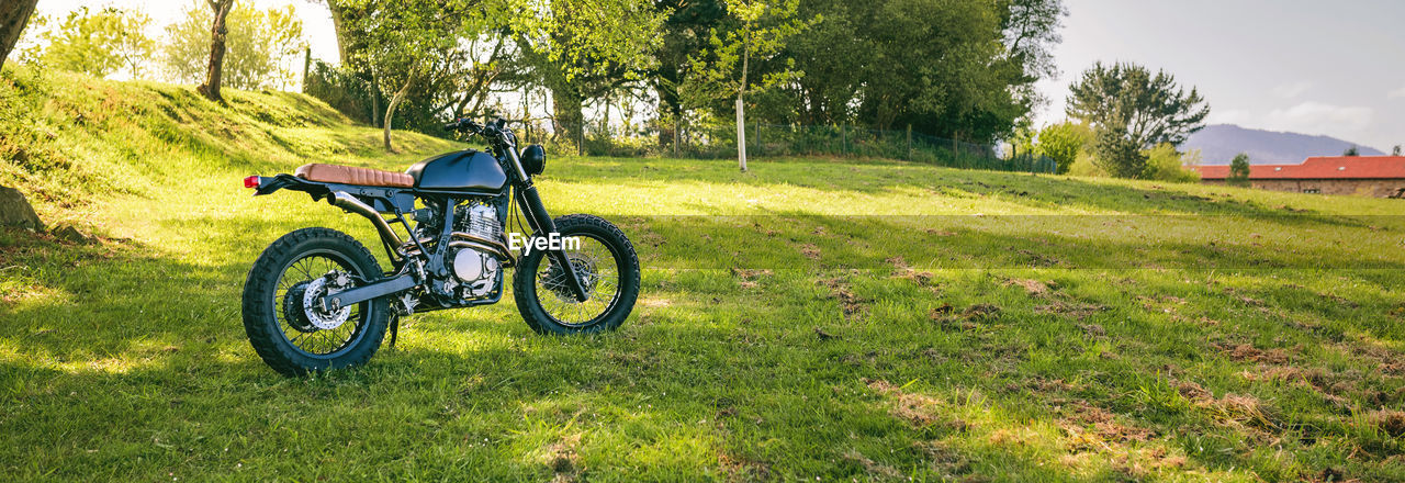 Beautiful vintage custom motorcycle parked on the field