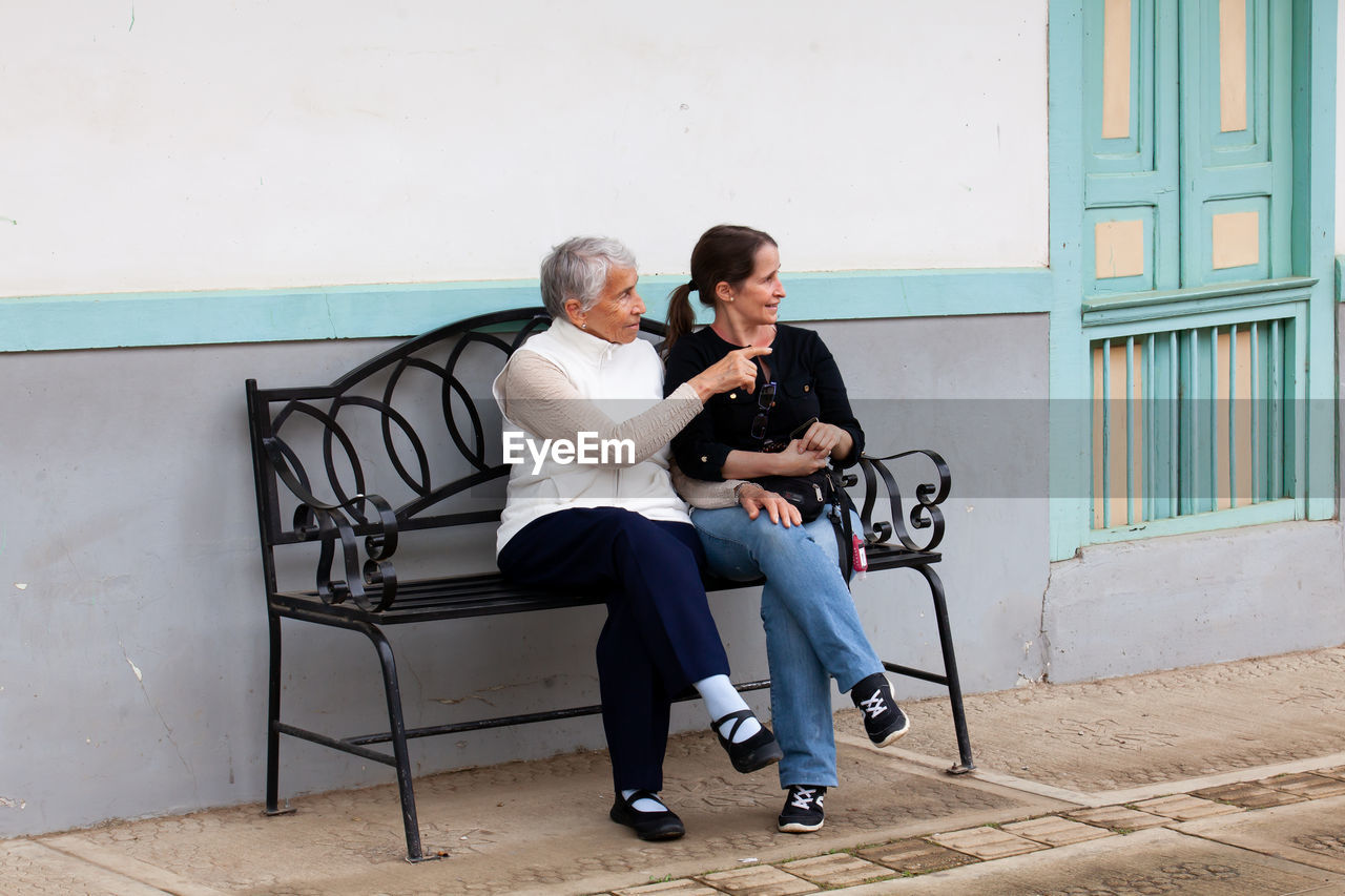 Senior mother and adult daughter traveling together at the small town of salento in colombia