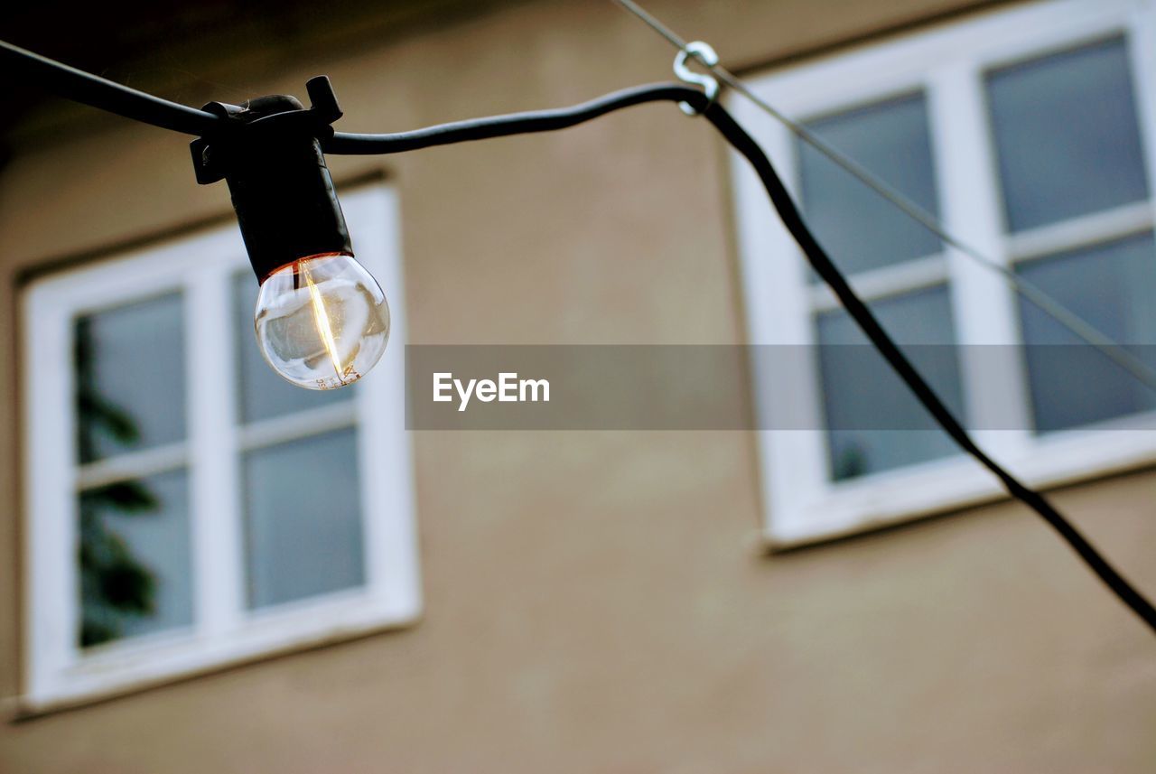 Low angle view of light bulb hanging