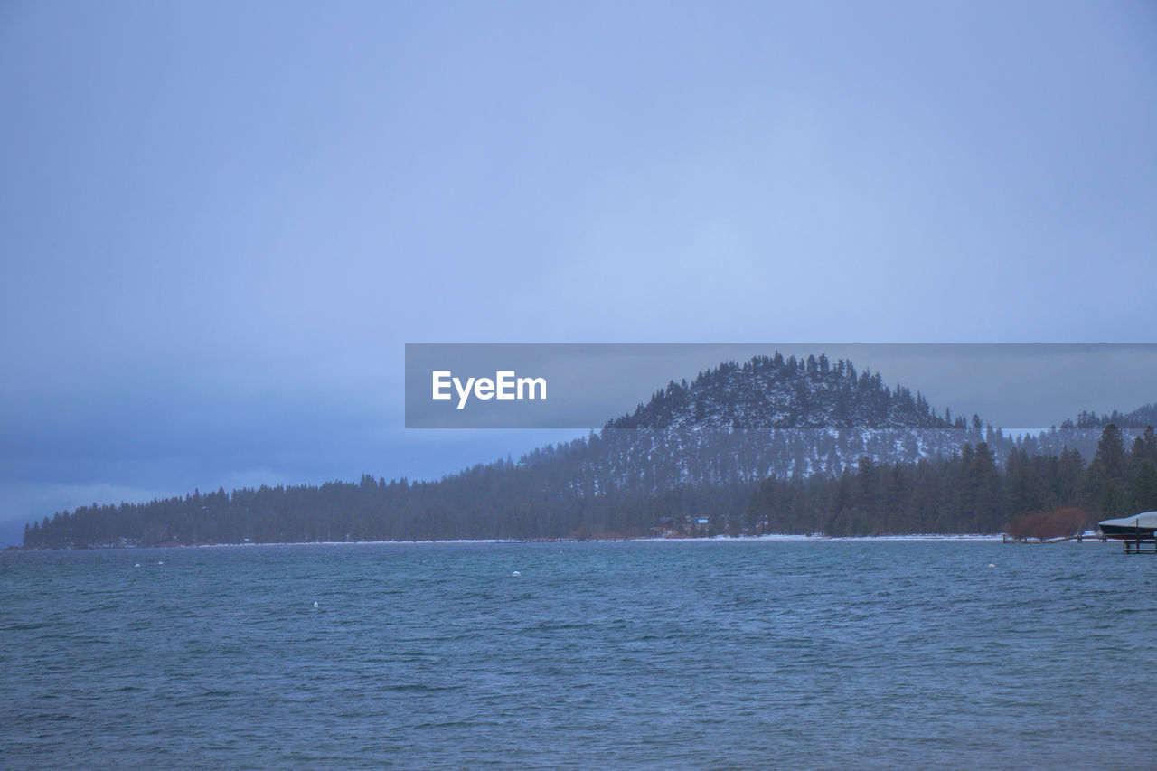 SCENIC VIEW OF LAKE IN WINTER AGAINST SKY