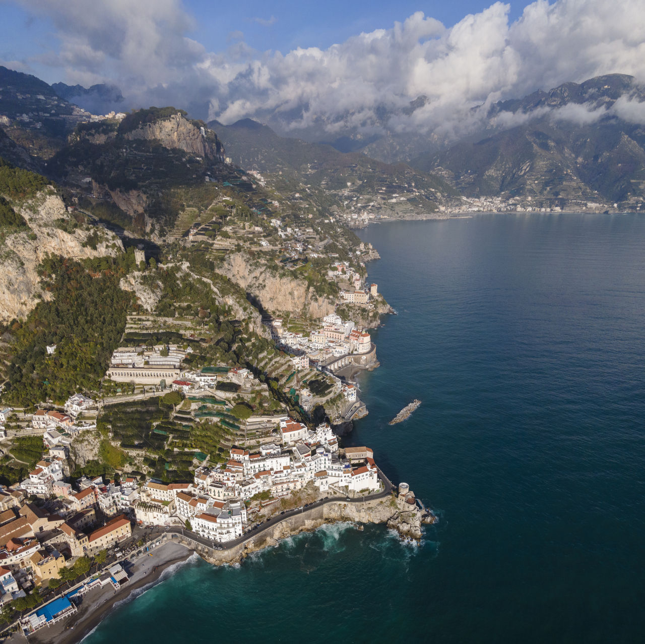 High angle view of sea and mountains against sky