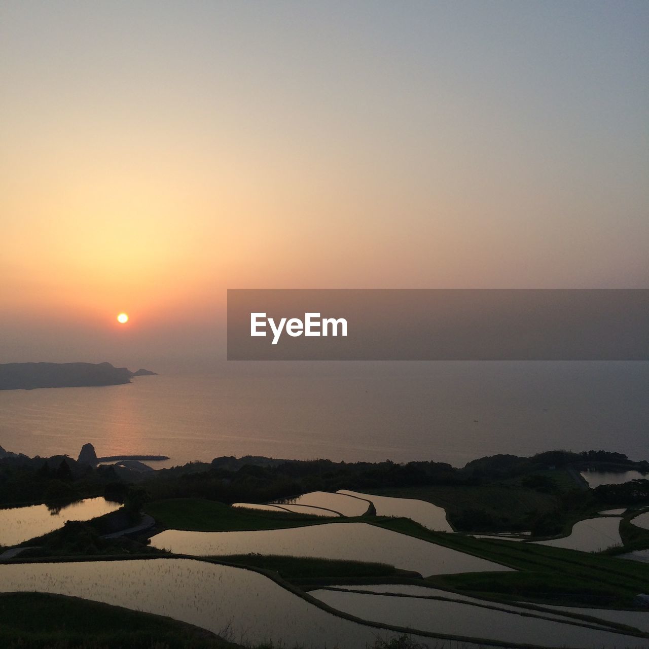 Scenic view of sea against sky at sunset