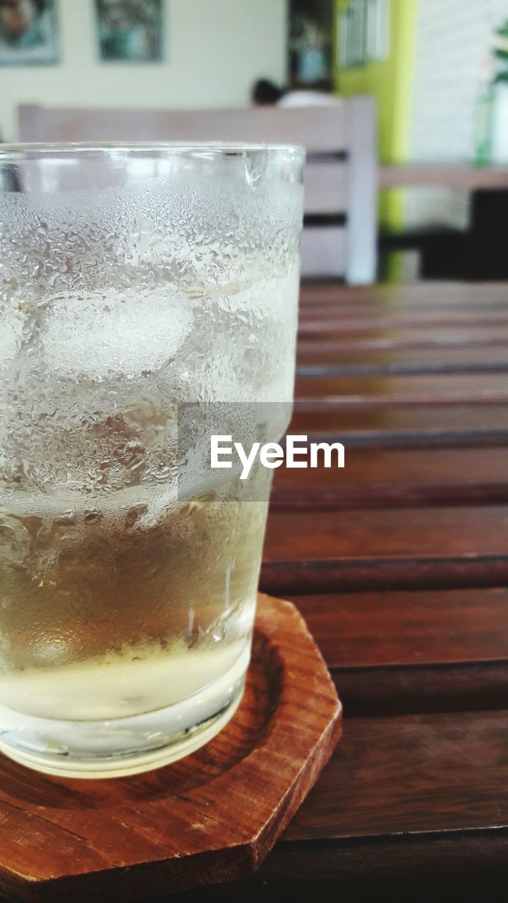 Close-up of whiskey glass on table