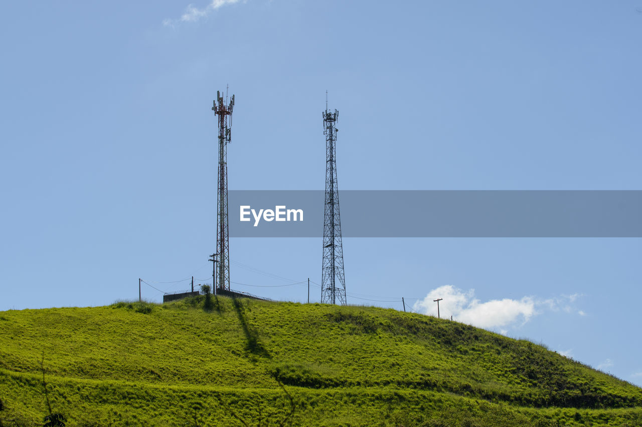 Mobile cell tower in open field with blue sky in countryside