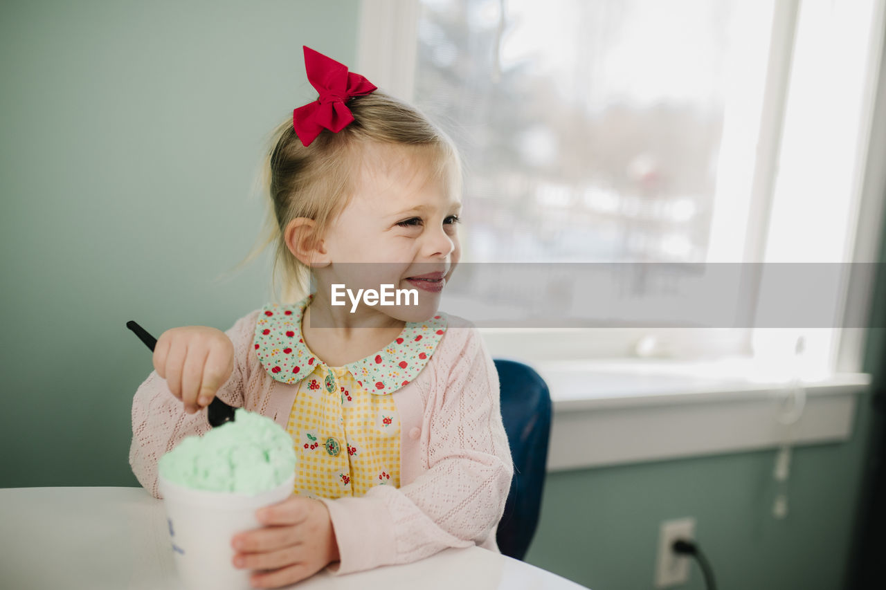 Girl eating ice cream happy