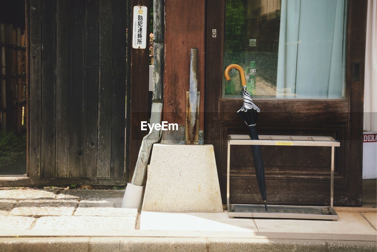 Umbrella against wooden wall