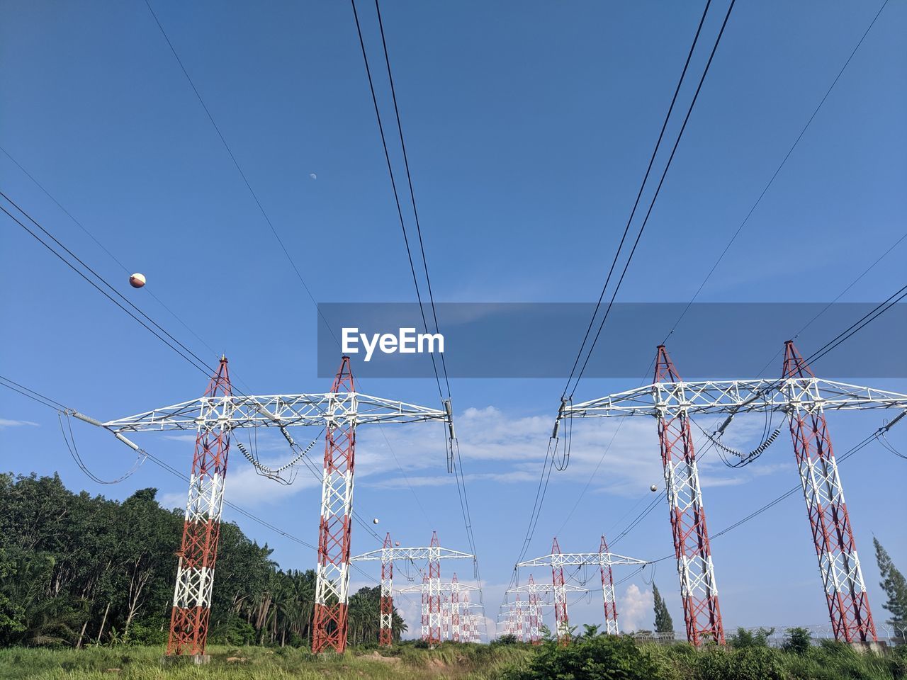 LOW ANGLE VIEW OF ELECTRICITY PYLON ON FIELD