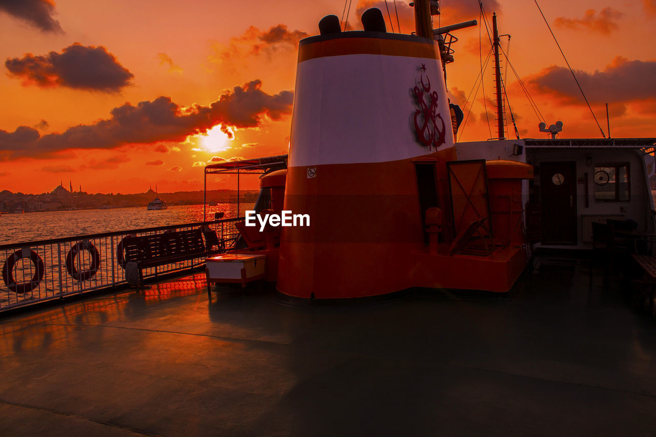 Cropped boat in calm sea at sunset