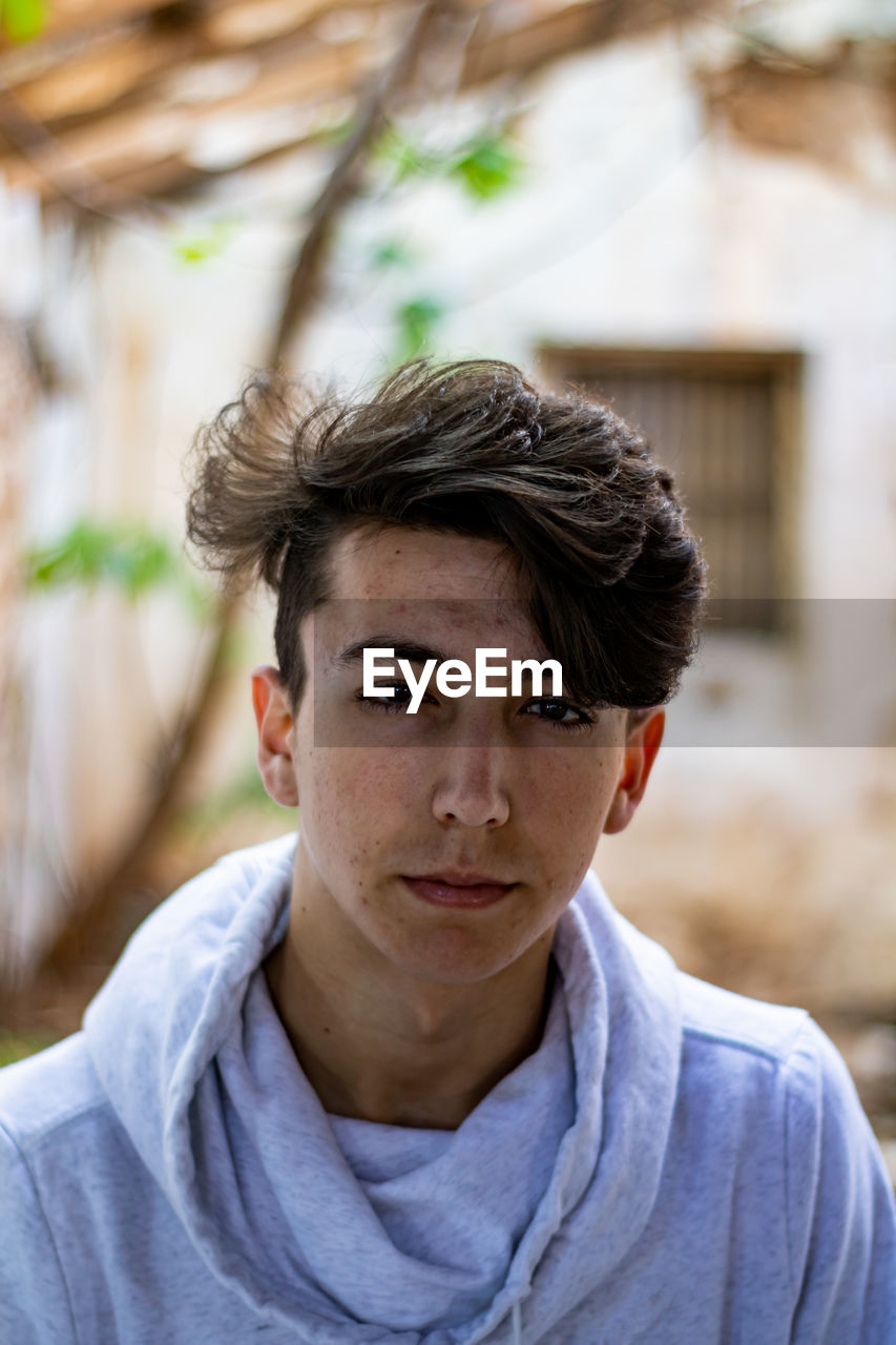 Portrait of young man standing outdoors