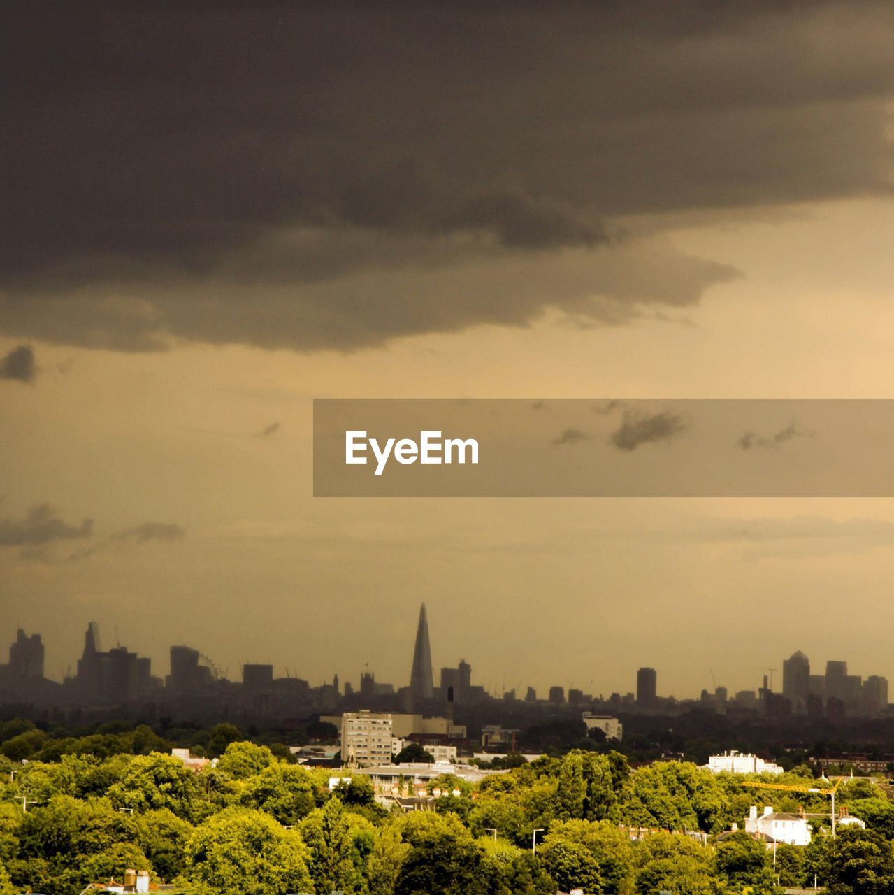 CITYSCAPE AGAINST CLOUDY SKY