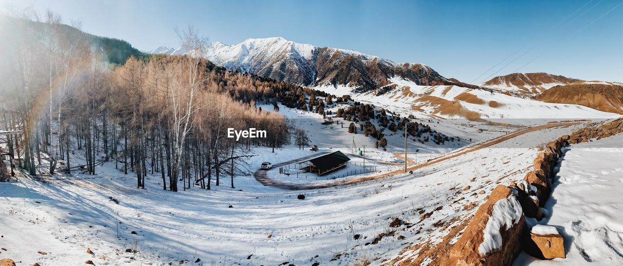 Scenic view of snow covered mountains against sky