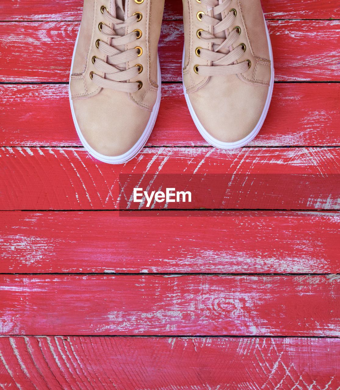 High angle view of shoes on red floorboard