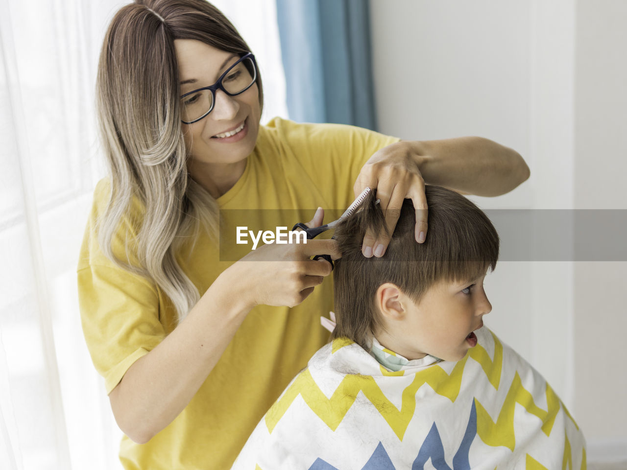 Mother cuts her son hair. new normal in quarantine of coronavirus covid-19. home lifestyle.