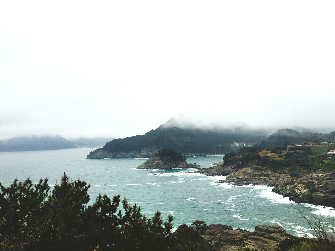 Scenic view of sea and mountains against sky