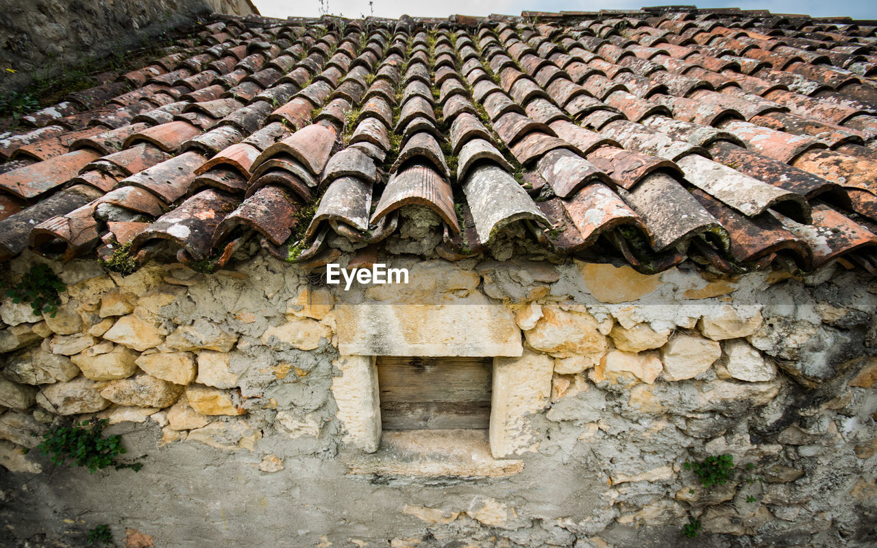 STONE WALL OF OLD HOUSE WITH BUILDING