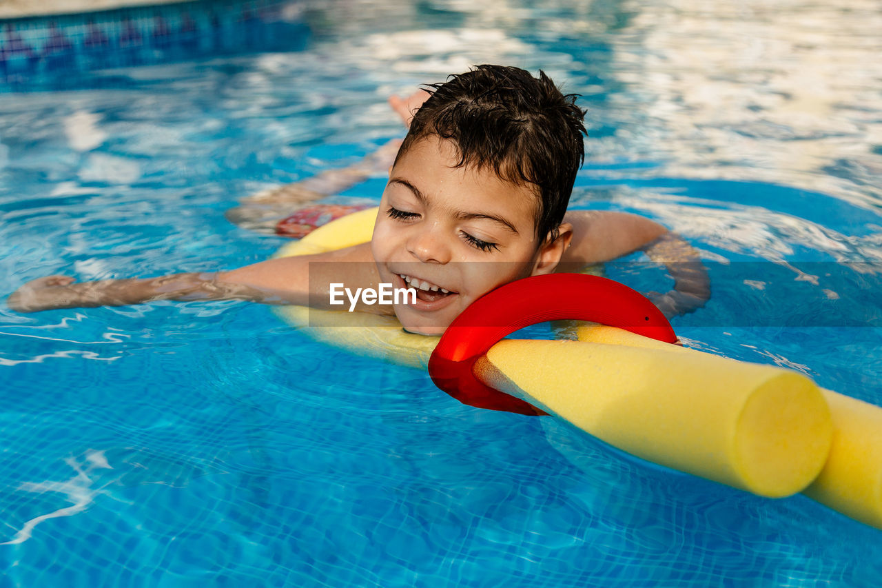 Smiling boy swimming in pool