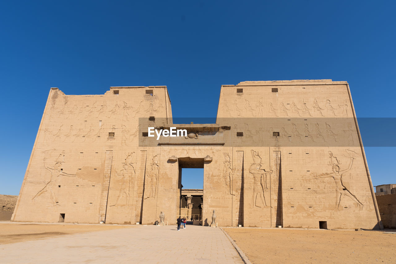 Low angle view of historical building against clear blue sky