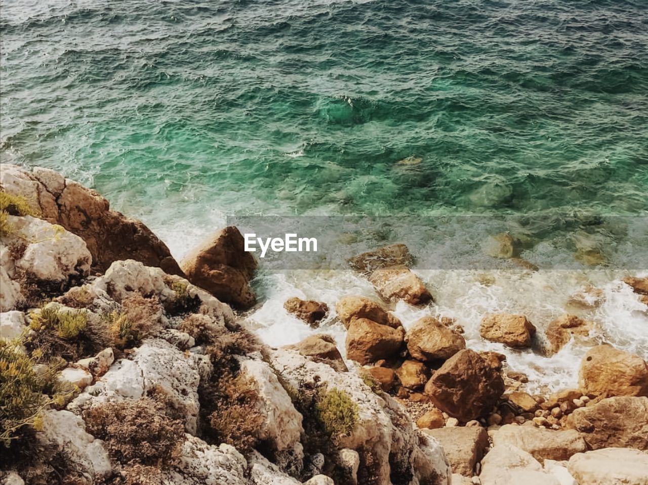 High angle view of rocks on shore