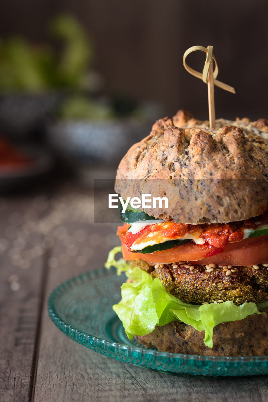 Close-up of fresh burger served in plate on table