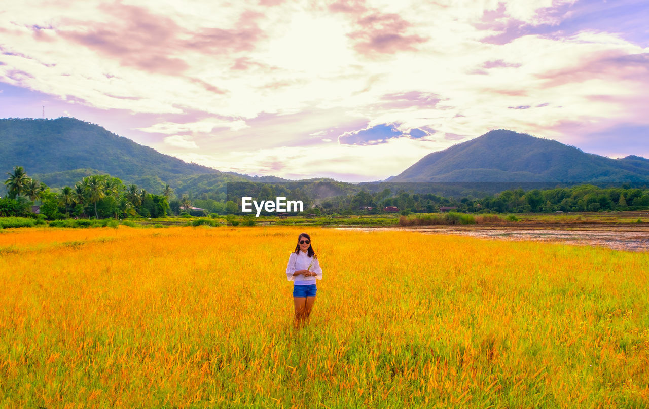 Portrait of woman standing on land