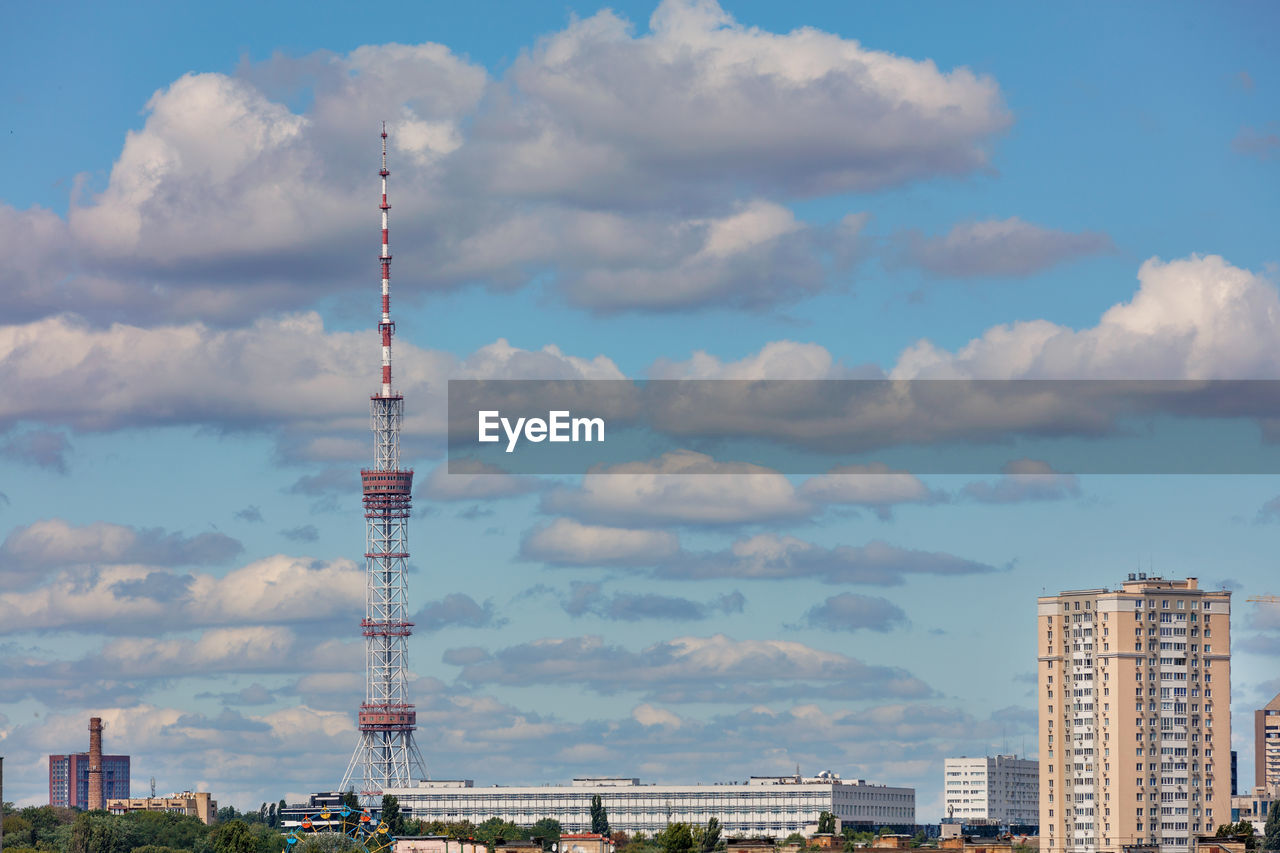 Cityscape of kyiv, city television tower against a blue cloudy sky.