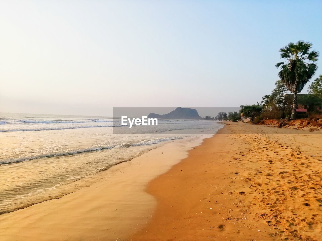 Scenic view of beach against clear sky