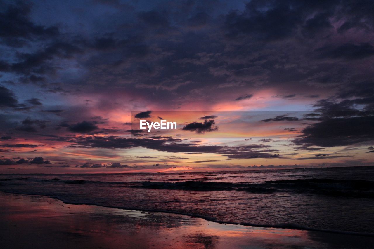 Scenic view of dramatic sky over sea during sunset