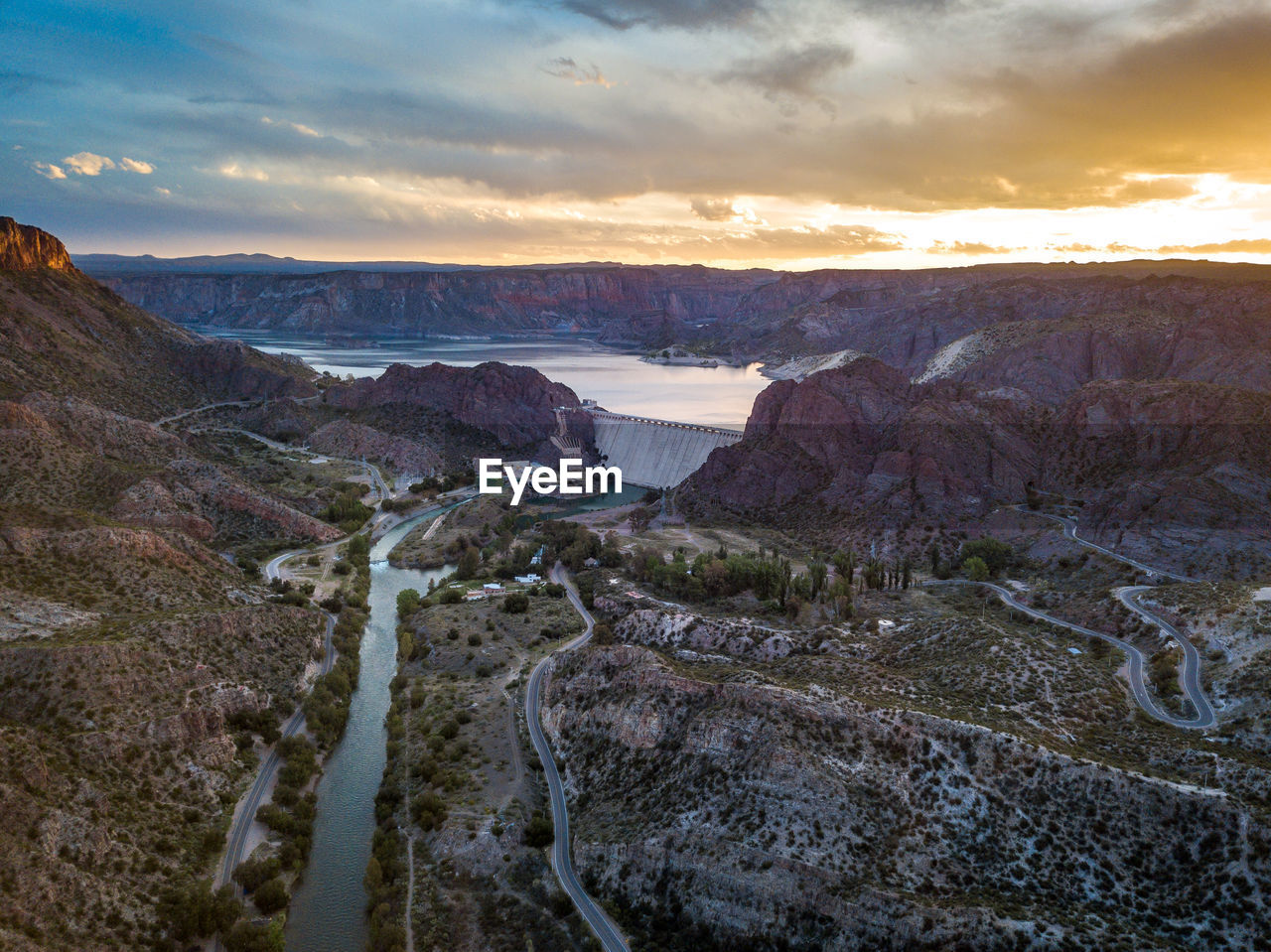 Scenic view of river against sky during sunset