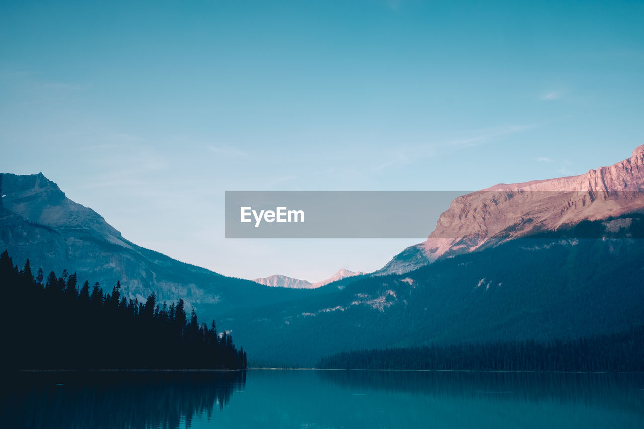 Scenic view of snowcapped mountain against blue sky