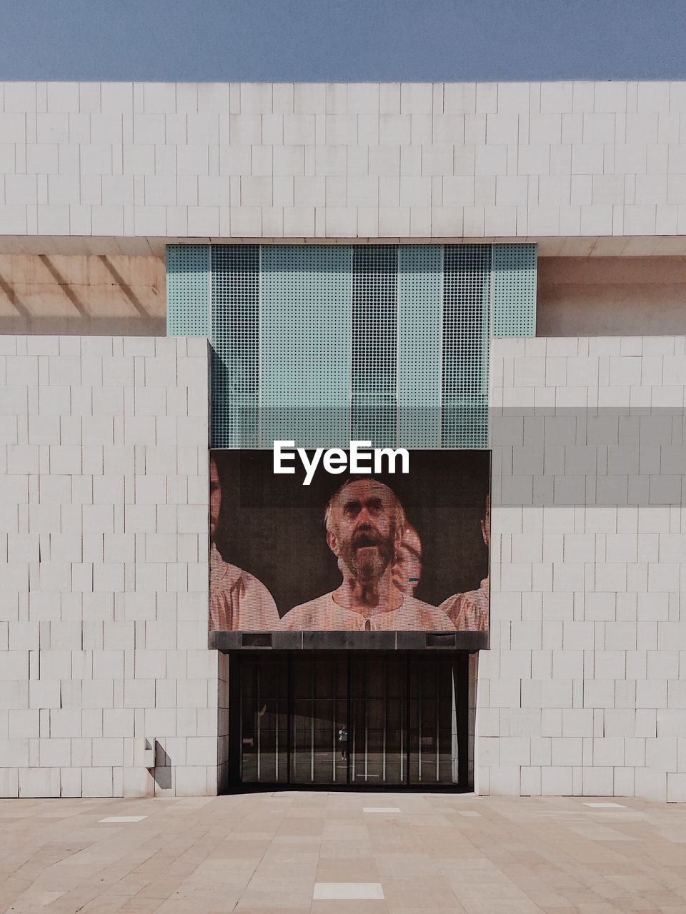 PORTRAIT OF WOMAN ON BUILDING WALL