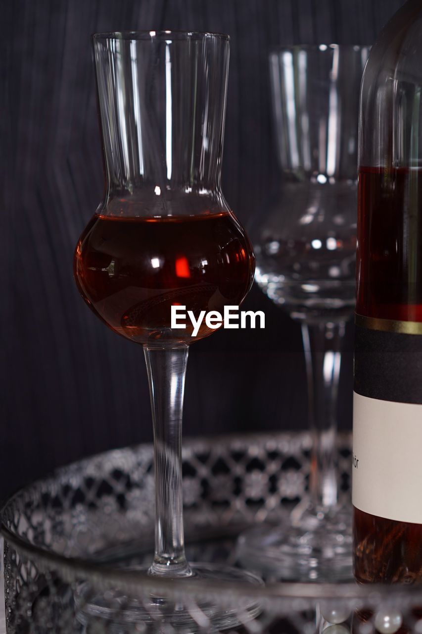 CLOSE-UP OF BEER GLASS ON TABLE