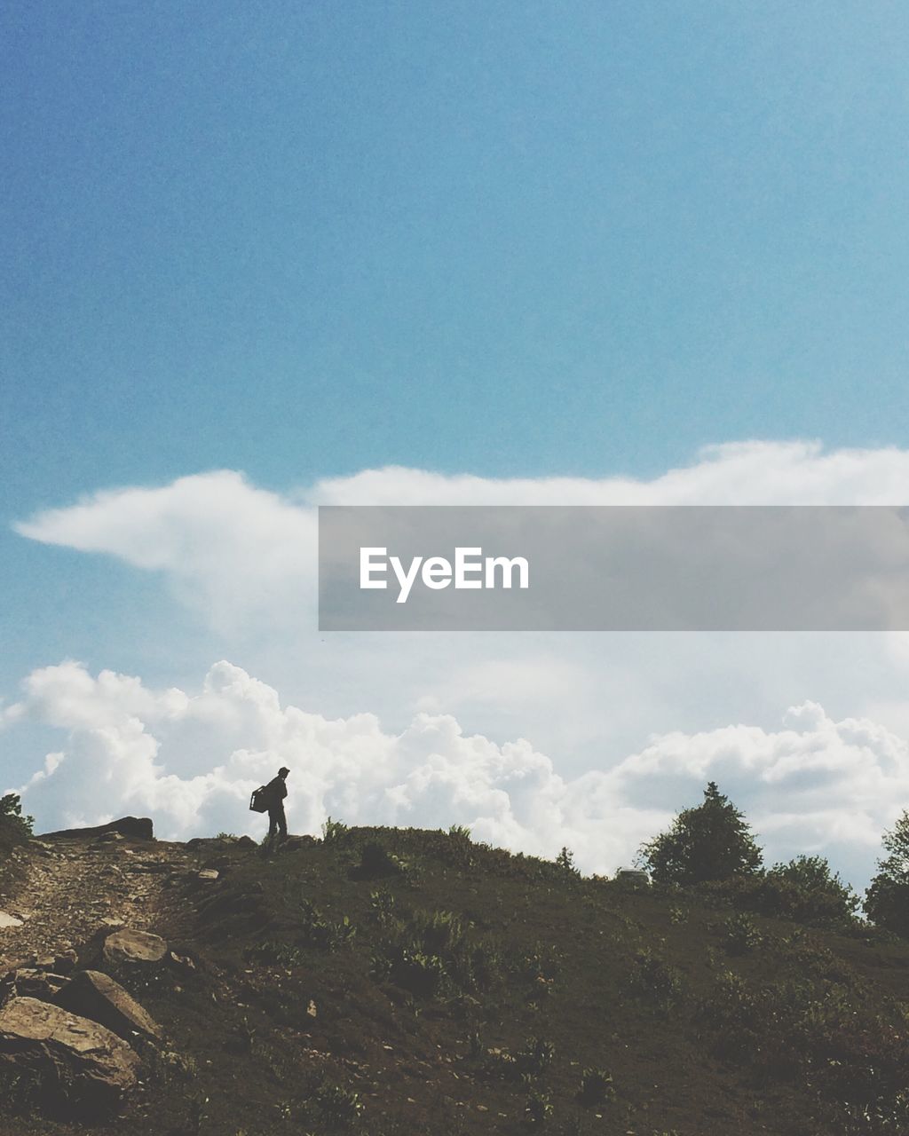 Man walking on mountains against sky