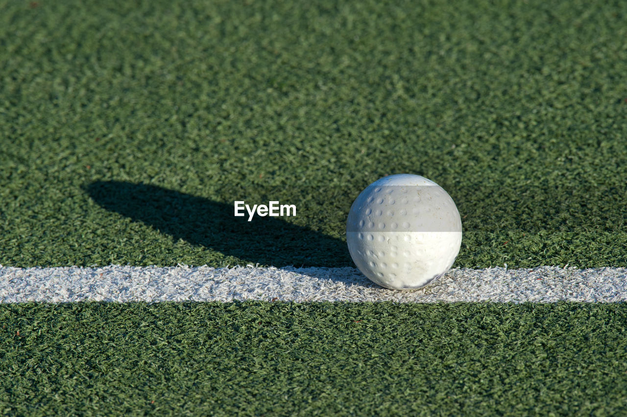 CLOSE-UP OF A BALL ON FIELD