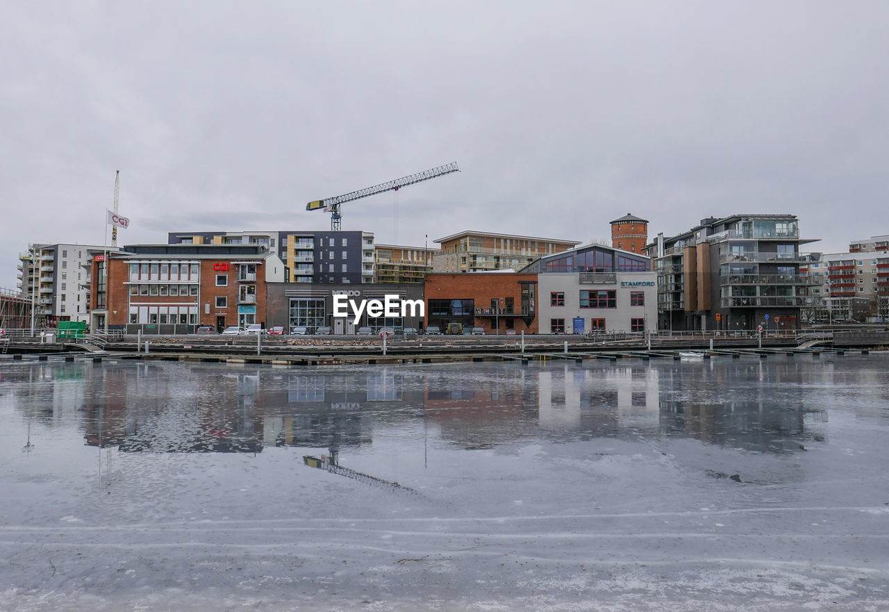 BUILDINGS AGAINST SKY DURING WINTER SEASON