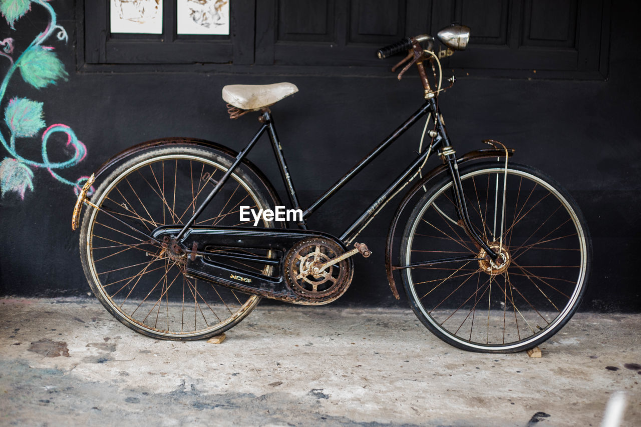 BICYCLE PARKED IN FRONT OF BUILDING