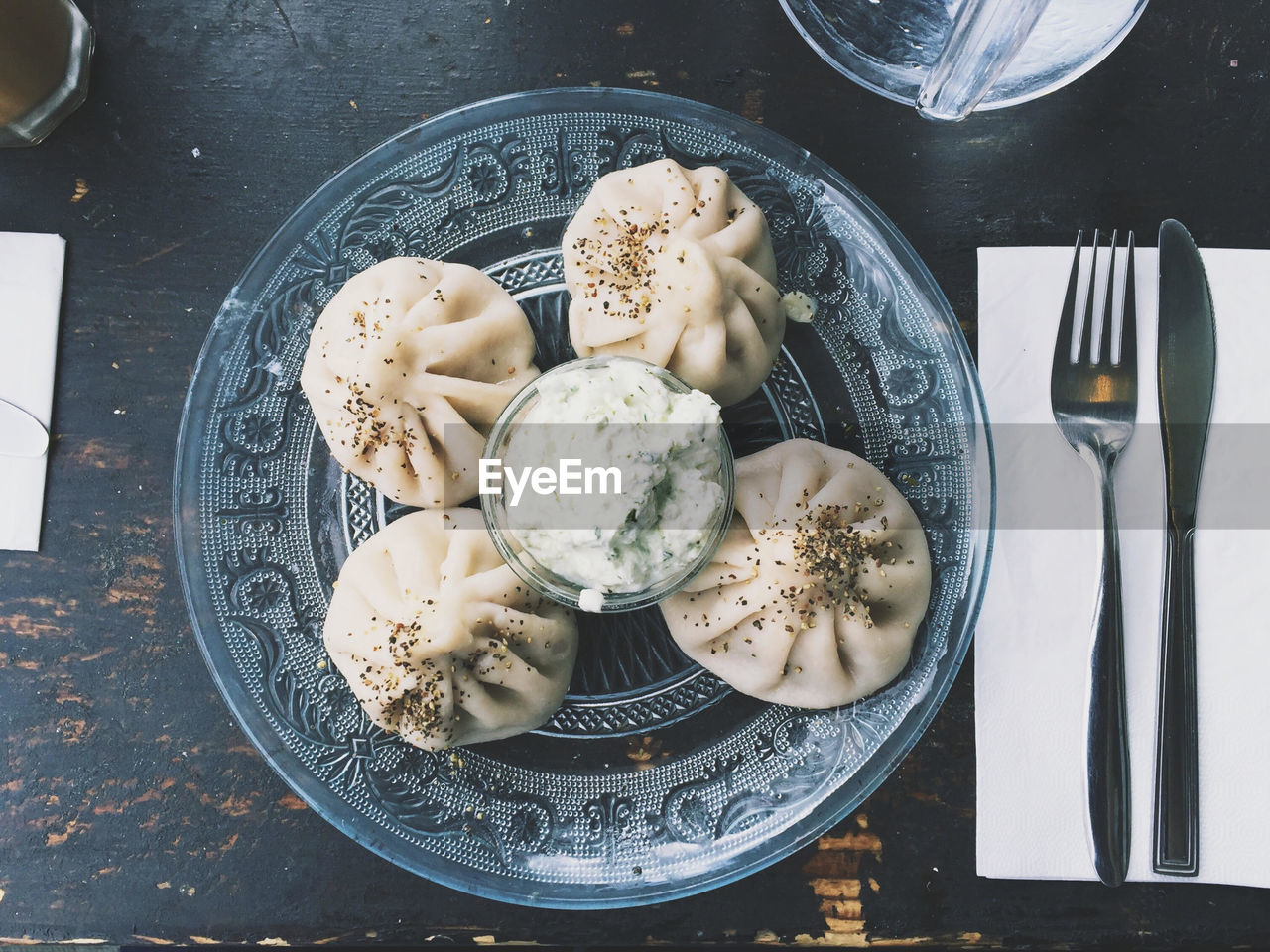 Directly above shot of dumplings served in glass plate on table