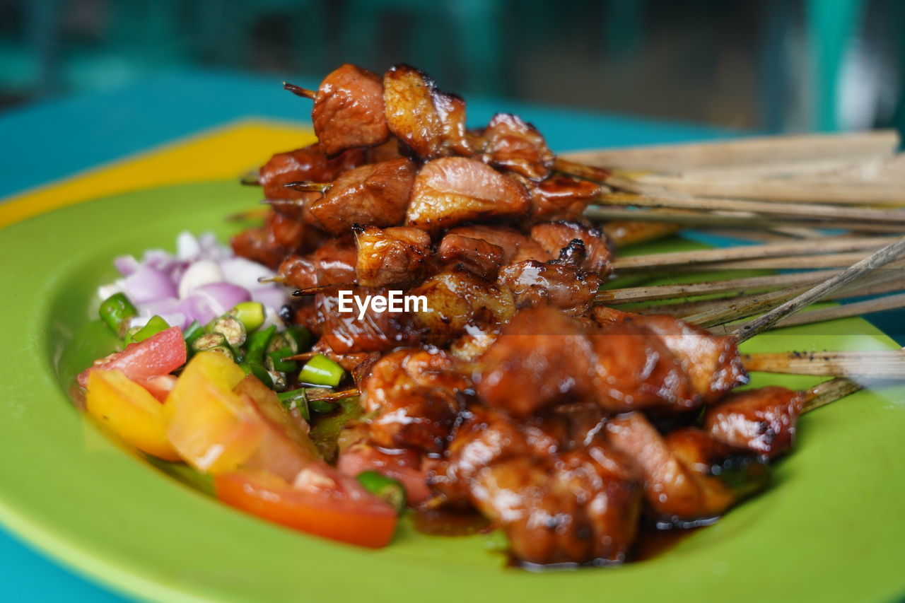 Close-up of served satay in plate