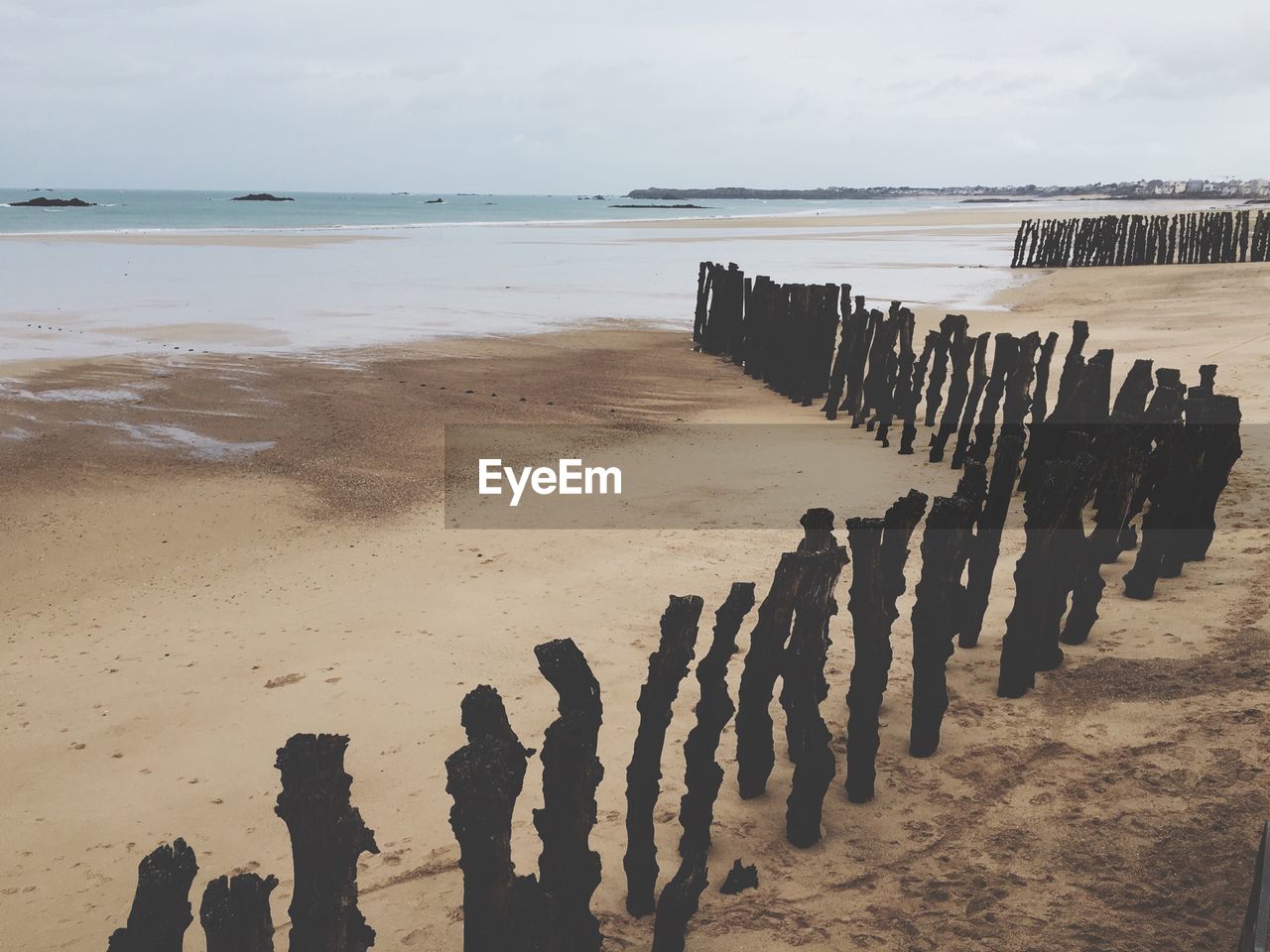 Wooden posts on beach