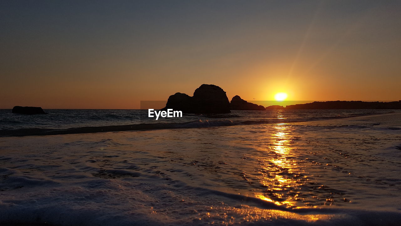 Scenic view of sea against sky during sunset