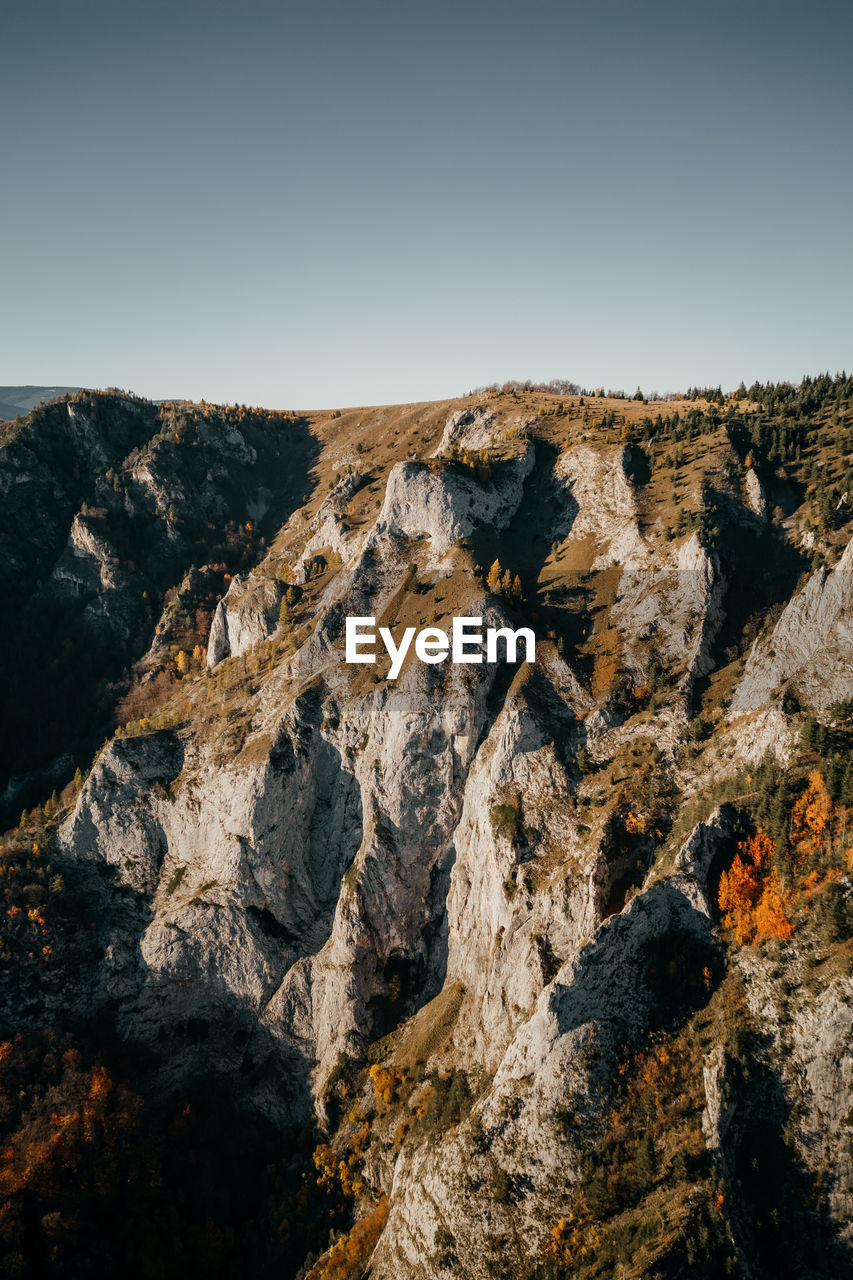 low angle view of rock formations against sky