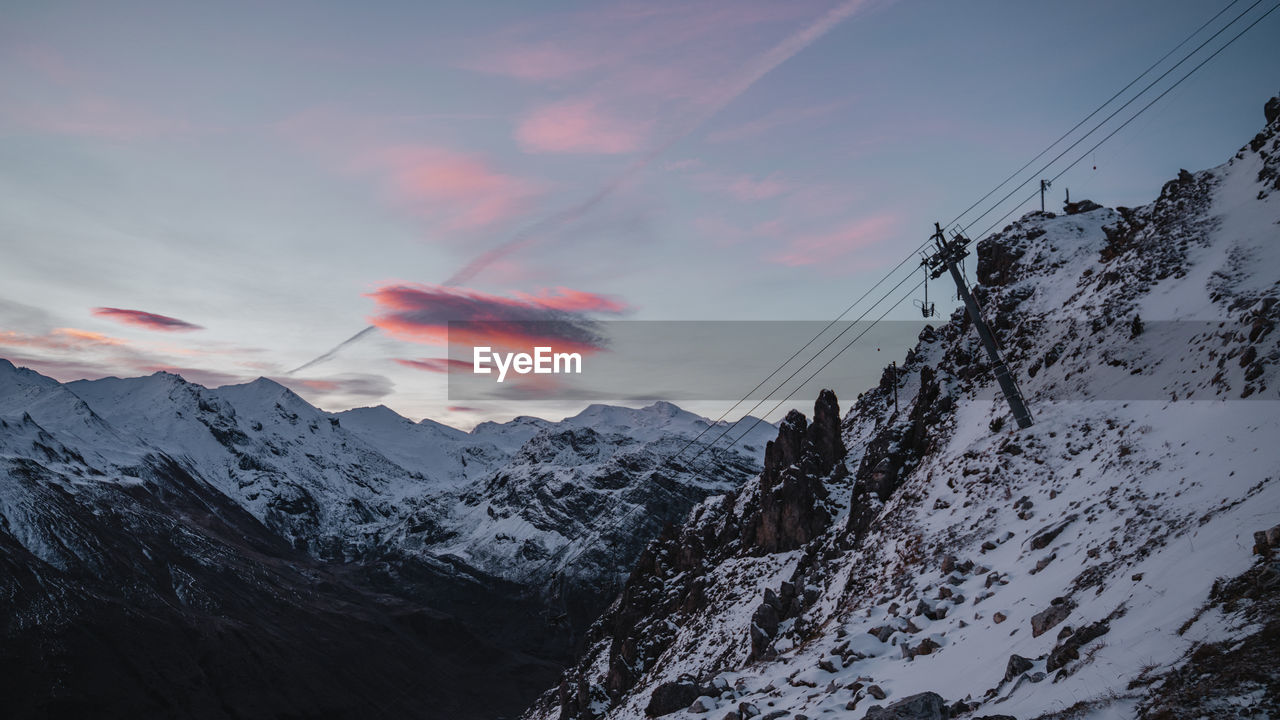 Scenic view of snowcapped mountains against sky during sunrise