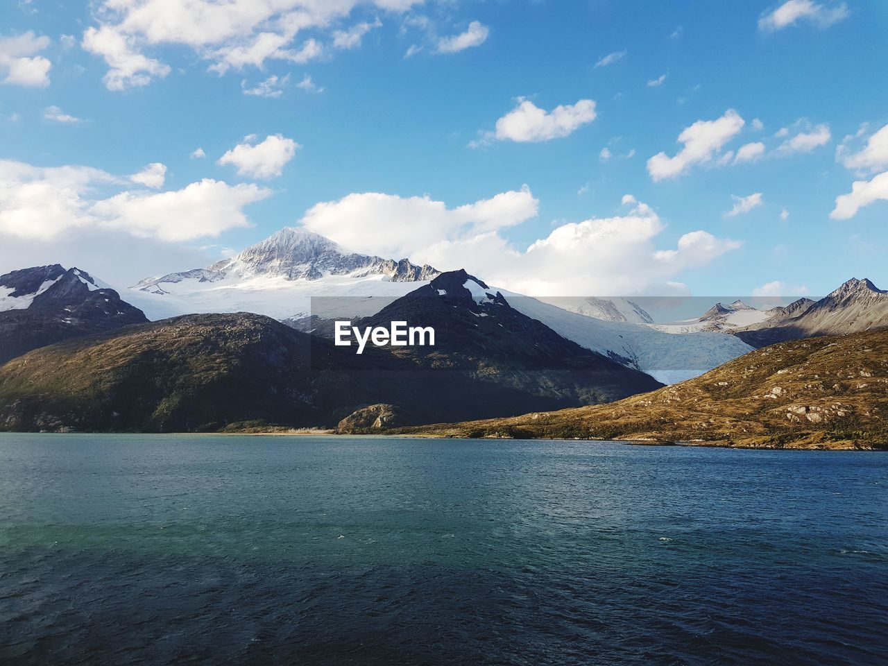 Scenic view of lake and mountains against sky