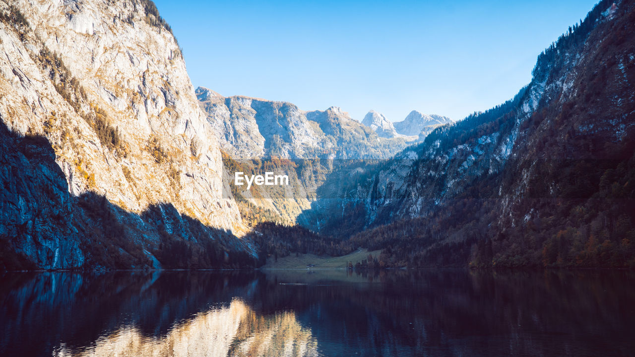 Scenic view of lake and mountains against sky