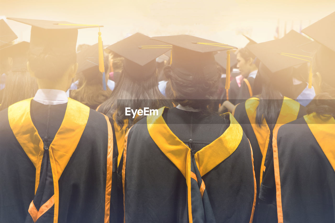 Rear view of students wearing graduation during ceremony