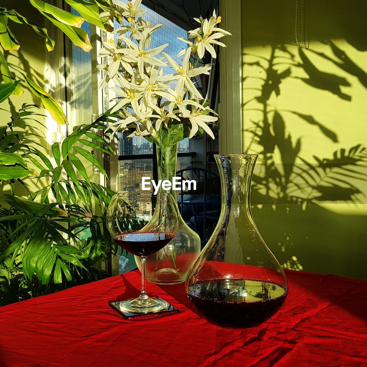 CLOSE-UP OF WINE GLASSES ON TABLE AT HOME