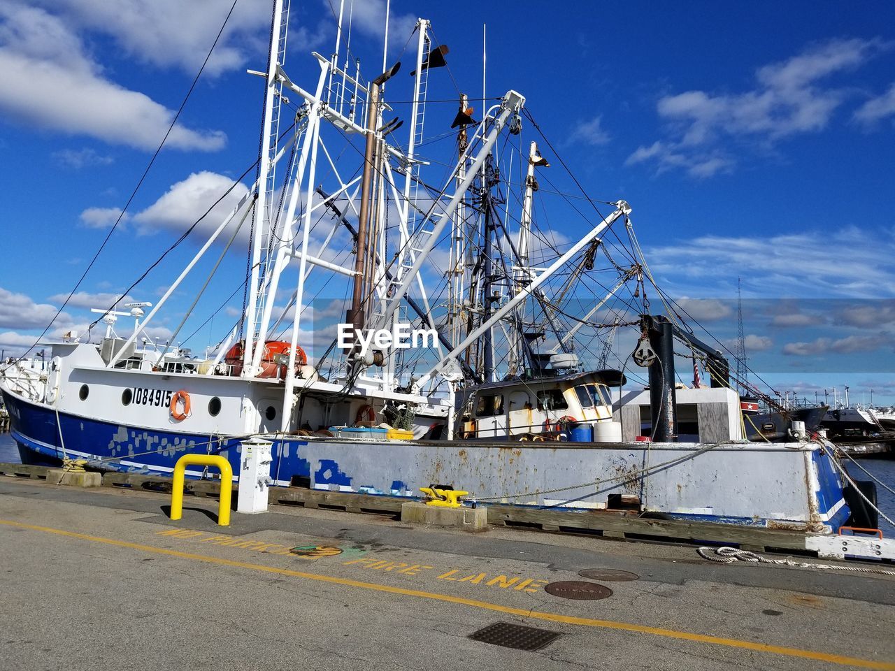 SAILBOATS MOORED AT HARBOR